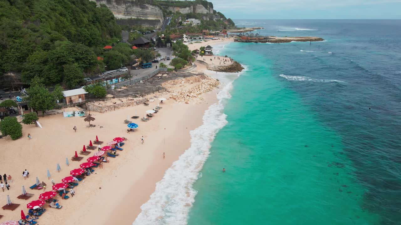 Melasti Beach in Uluwatu with sunbeds and turquoise beach in Bali, Indonesia