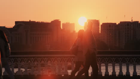 anonymous crowd of people walking  at sunset commuters london city street slow motion