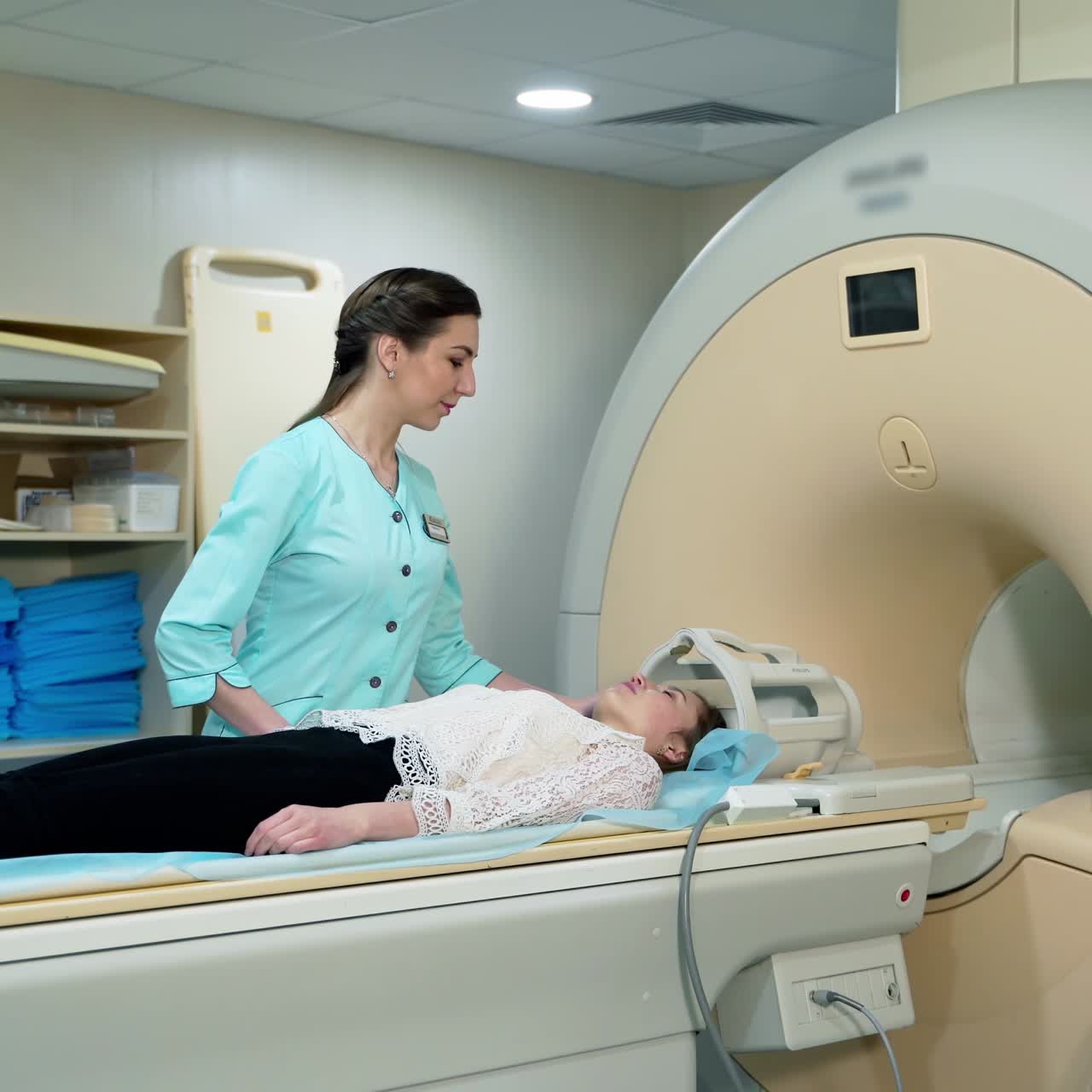 Magnetic resonance image device in hospital. Female patient lying in MRI machine and medical worker controls the procedure. Advanced medicine.