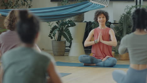 women practicing yoga in group