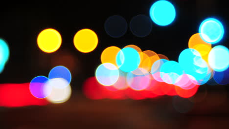 The-footage-is-out-of-focus-to-create-beautiful-circle-Bokeh-of-car-lights-moving-rapidly-at-an-intersection