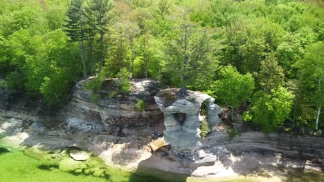 Aerial-Ascent-of-Coastal-Sandstone-Rock-Formations,-Chapel-Rock,-Pictured-Rocks-National-Lakeshore