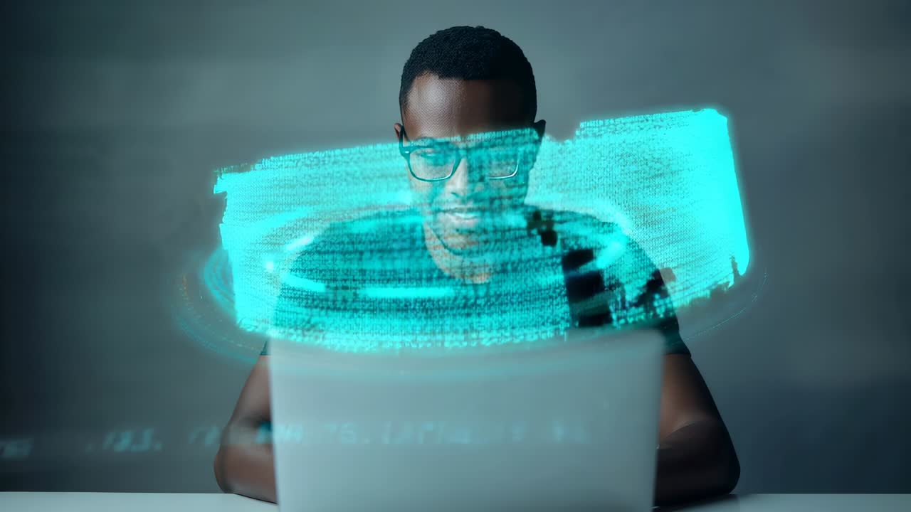 Watching man wearing glasses and dark shirt working at home desk laptop while data ring appearing