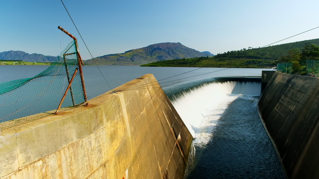 Theewaterskloof dam filled to capacity with water overflowing at spillway