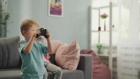 cute blond boy feels happy to bead sister while playing game