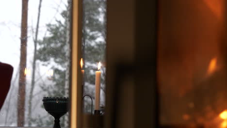 wood burns in stove during winter snowfall