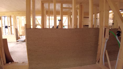 panning inside a half finished hempcrete wall and zooming into electrical installation tubes in wooden frame