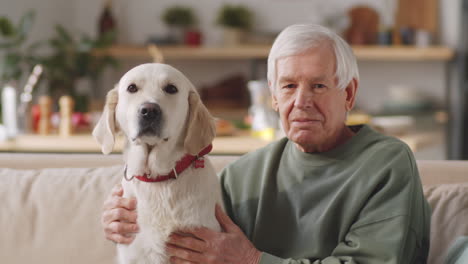 portrait of elderly man with dog at home