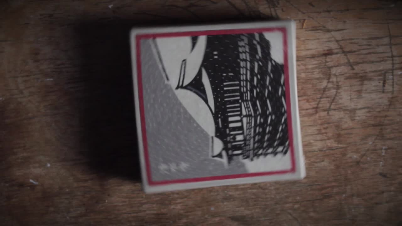 Spinning Card with Japanese Illustration on Wooden Surface