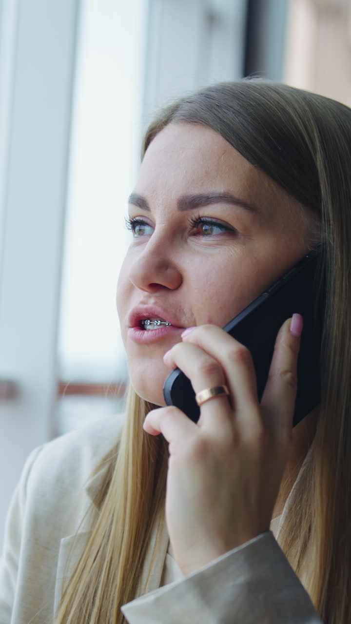 Lady office worker have a phone call. Pretty business woman working with smartphone. Vertical video