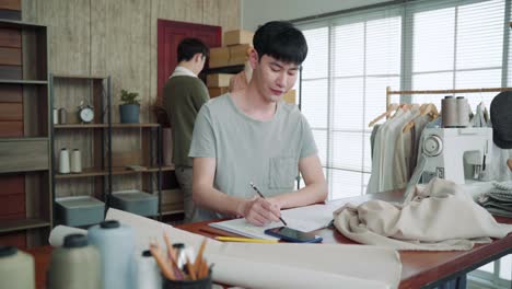 young smart asian lgbtq men join work together partnership, small business starts up designer, clothing business shop owner, freelancer work at home or office studio, business friendship partner.