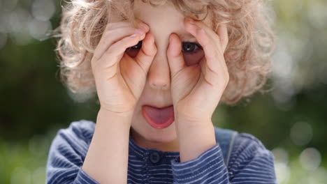 portrait funny little boy making faces having fun kid enjoying making silly expressions in sunny park 4k