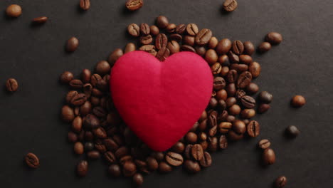 hand putting heart shape into beans