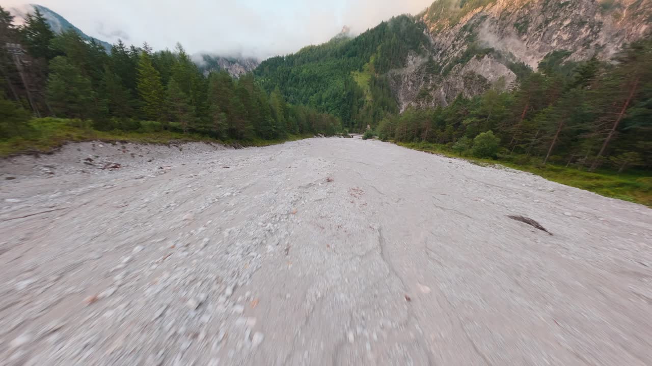 Dry mountain river and forest landscape in Gesäuse National Park, FPV drone