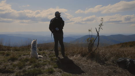 backpacker and his dog at the top of the hill