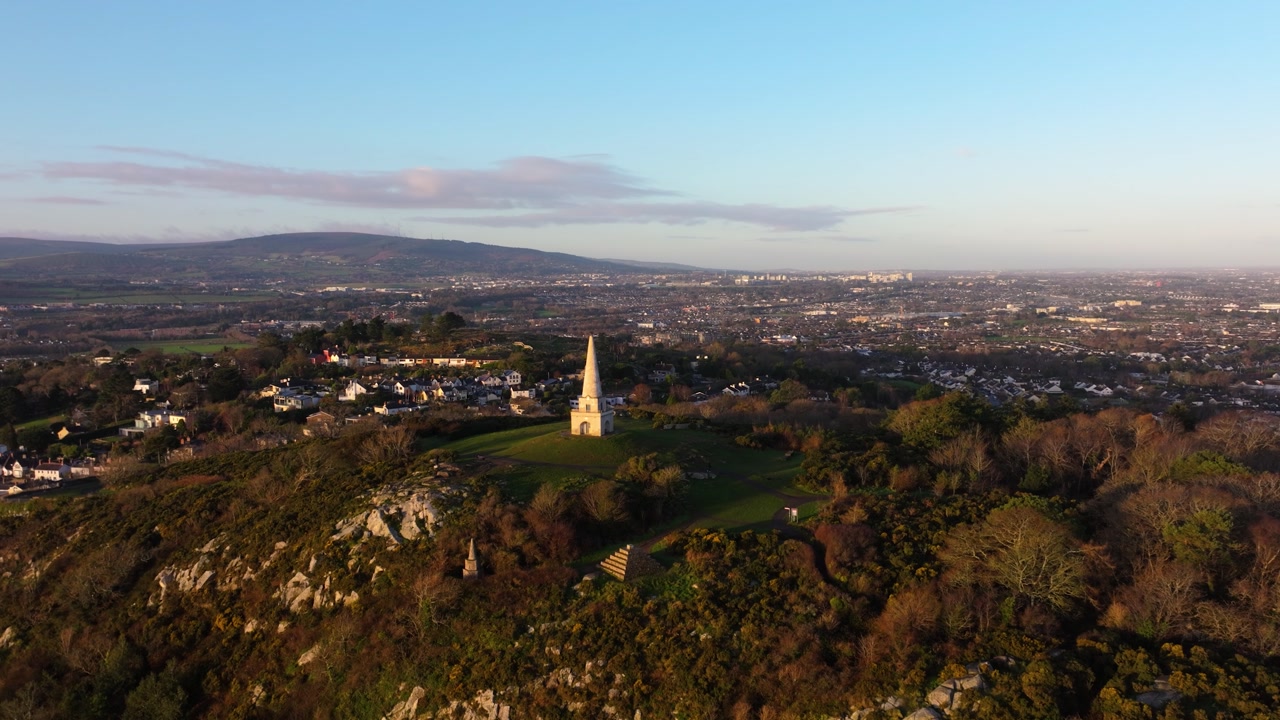 The Killiney Hill obelisk stands prominently on a rugged hillside, with sweeping views of Dublin city and surrounding landscapes. Ideal for travel and documentary projects.