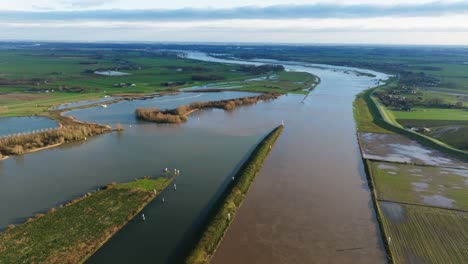 drone view of flooded agricultural fields on the outer banks of the lek river, netherlands