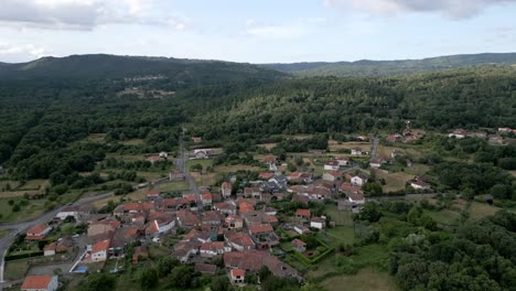 Drone-dolly-above-countryside-homes-along-the-forest-edge-of-spain