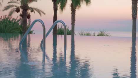 outdoor swimming pool on resort view at sunset