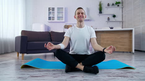 healthy lifestyle man doing yoga on quarantine. young fit man in sportswear working out at home. full length