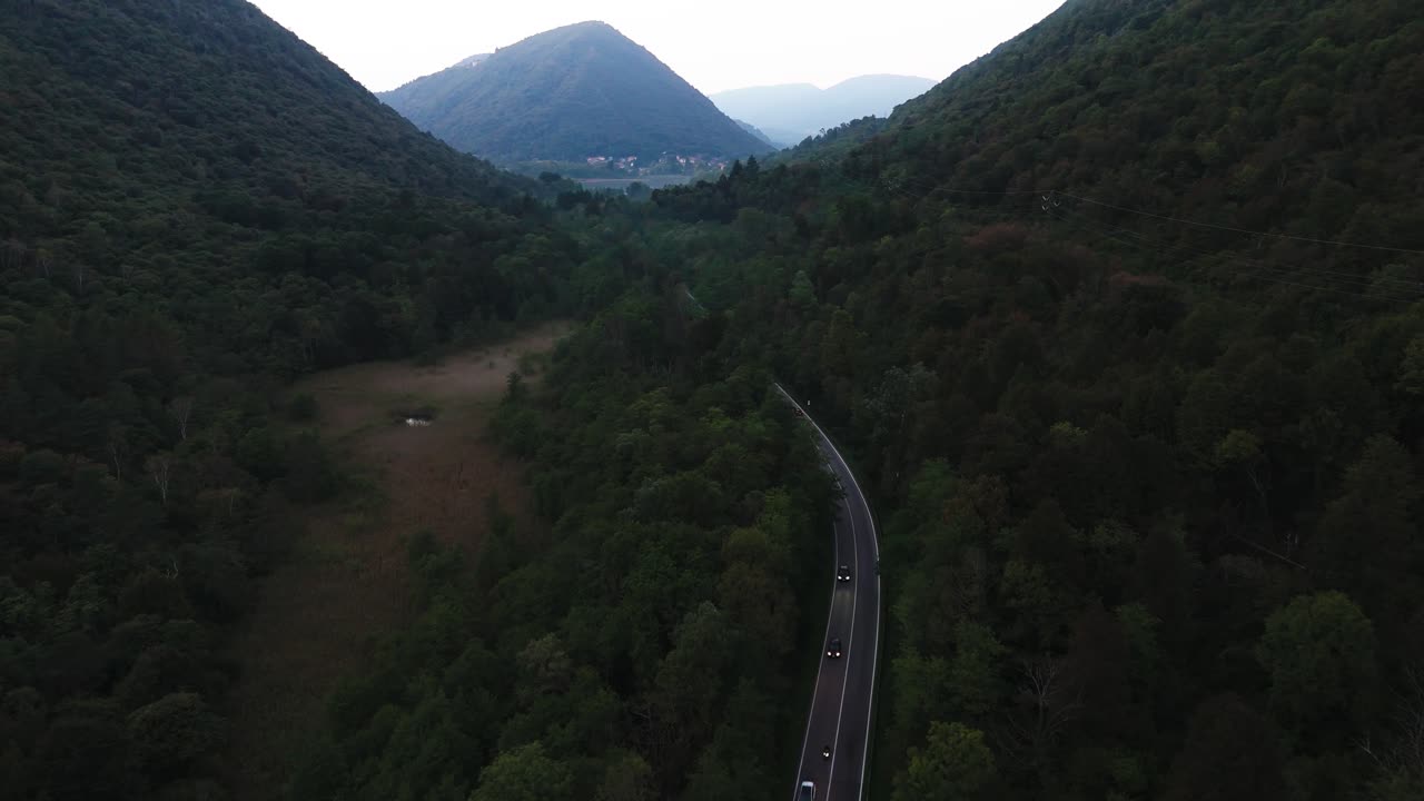 Fly over forest road in evening, Italy