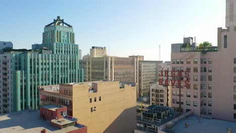 Vista-Aérea-Of-Older-Apartment-Buildings-And-Gentrified-Historic-Buildings-In-Downtown-Los-Angeles-Includes-Jesus-Saves-Sign-And-Eastern-Building-1