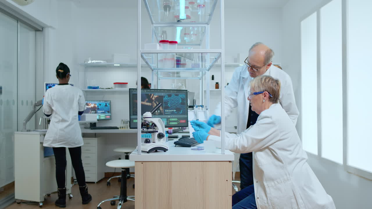 Team of elderly scientists discussing about vaccine development