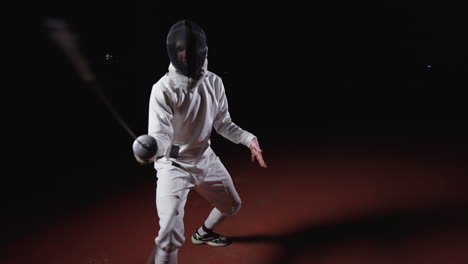 fencer in action, holding a foil sword