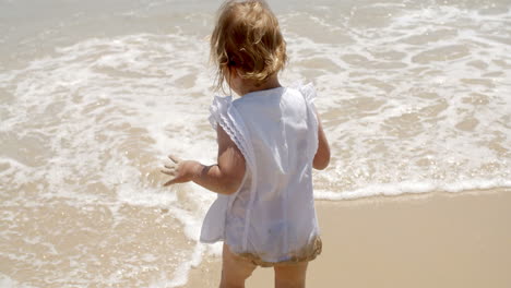 Little-girl-paddling-in-shallow-surf