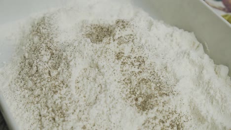 adding spice into cooking flour