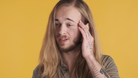 caucasian young man thinking in front of the camera.