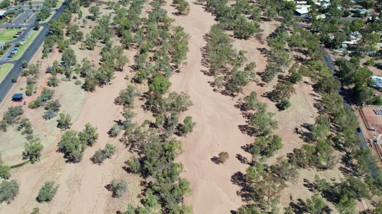 Aerial view of the dry Todd River in the full sun. Alice Springs, Mparntwe, Northern Territory, Australia. August 2022.