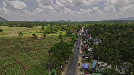 ibbagamuwa sri lanka aerial v4 low flyover small rural village town along dambulla road capturing farming fields, jungle landscape and hillside views - shot with mavic 3 cine - april 2023