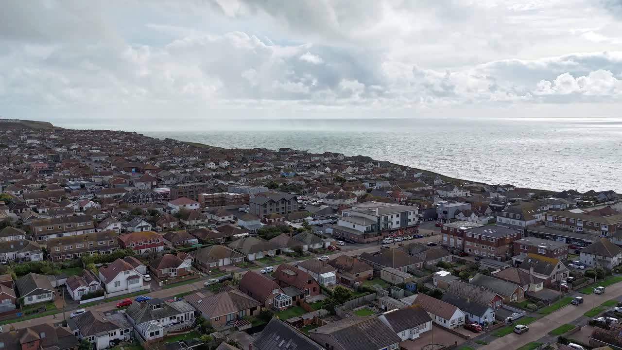 Stunning aerial hyperlapse of Peacehaven, Sussex, England. Dramatic coastal town perched on chalk cliffs along the South Coast, showcasing moving clouds, sea views, and breathtaking scenery
