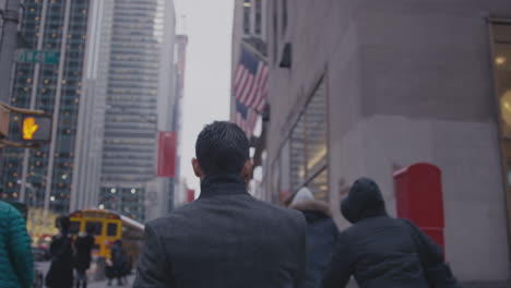 the people walk down the large city street