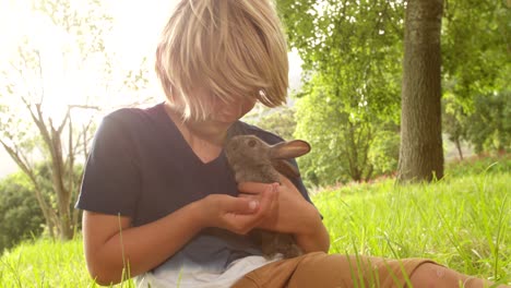 happy child taking care of a bunny outside