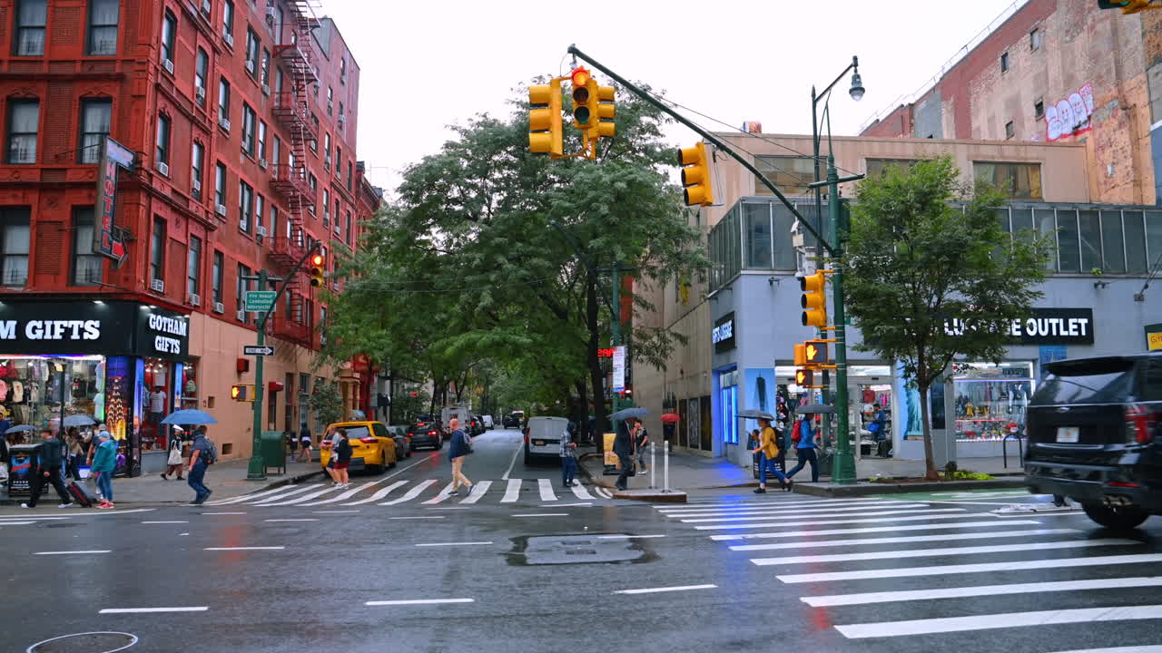 Strolling by the street of New York on a rainy day. Usual lifestyle of the vibrant metropolis at daytime