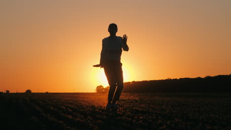 woman dancing at sunset in a field