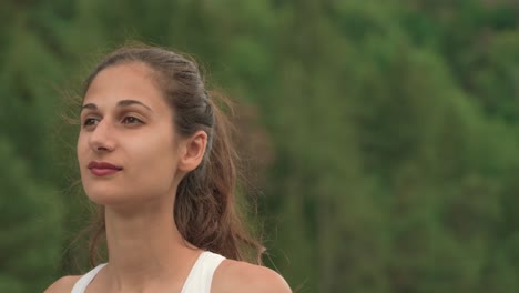 shifting from the face of a beautiful brunette woman to a tall building tower in the distance