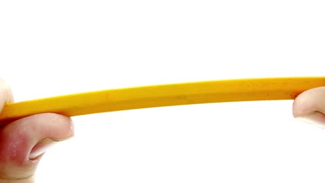 hands breaking pencil in half on white background