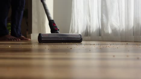 a man cleaning the floor with a vacuum cleaner