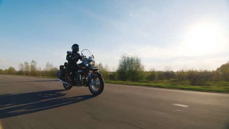 Shooting-From-The-Lowest-Point-Accompanied-By-Motorcycle---Biker-On-Country-Road