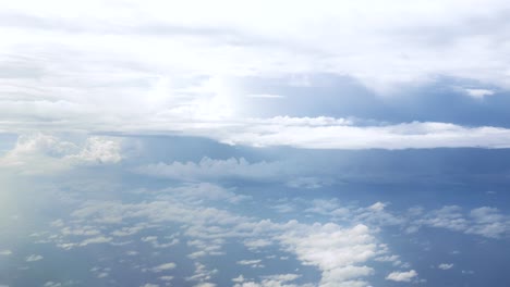 Flight-over-clouds,-a-view-from-a-plane-window---beautiful-blue-sky