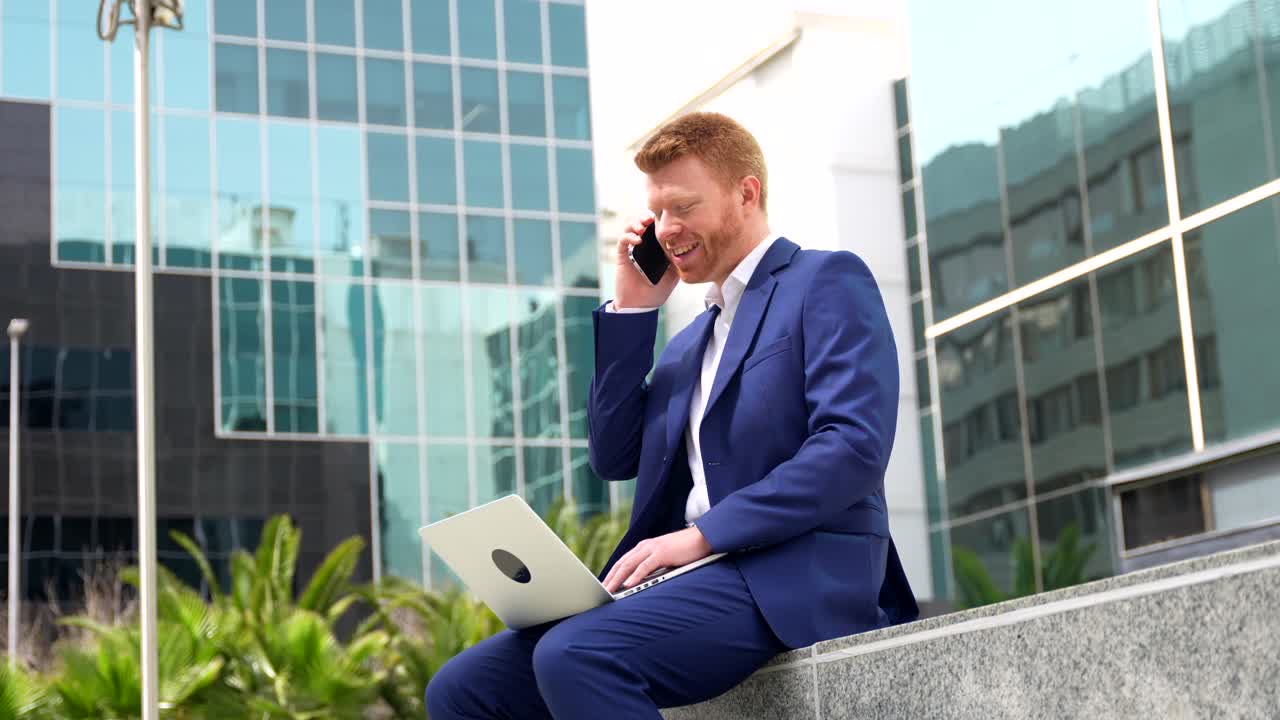 Businessman on a Phone Call with Laptop Outdoors