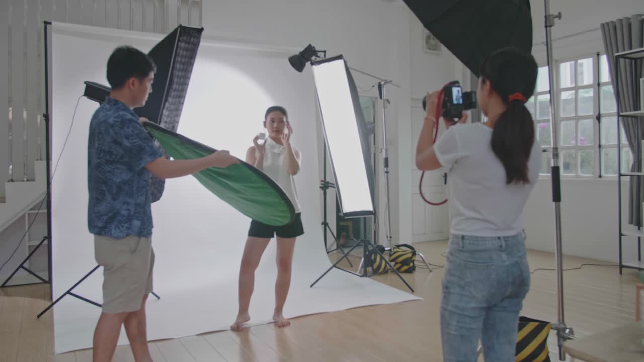 Photo shoot in a studio with model and photographers