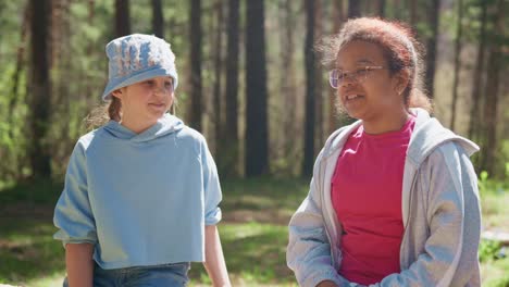 two girls talking in the forest