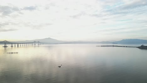 sunset white reflections of light on water, richmond bridge from point molate beach richmond california usa