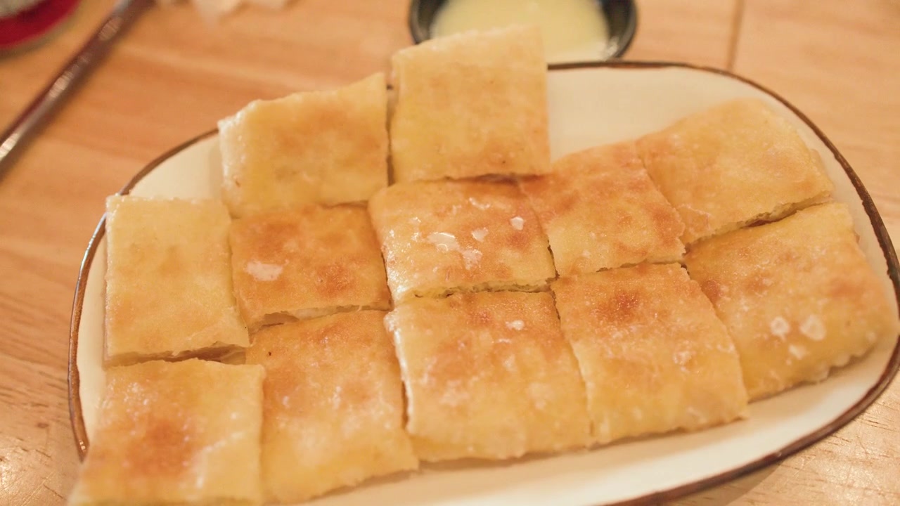 Piatto di pane Roti croccante servito con latte condensato dolce.