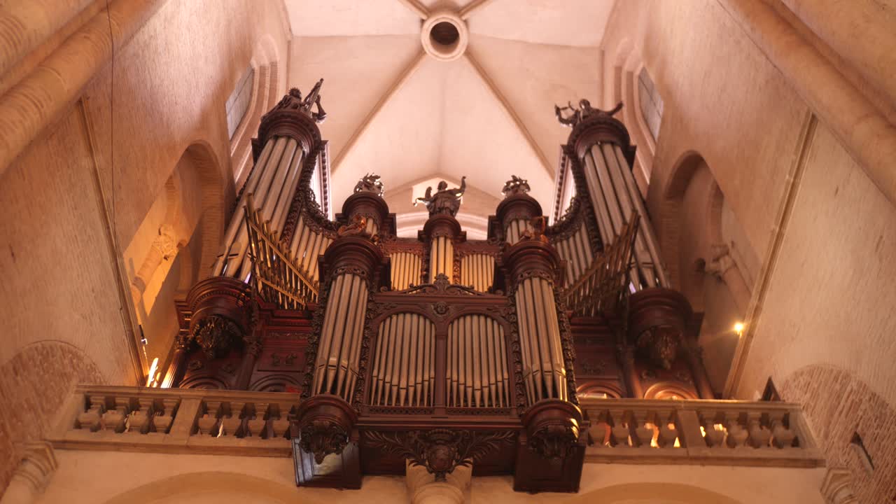 Interior shot of the pipe organ in Basilica of Saint Sernin, Toulouse, France, highlighting historic religious architecture