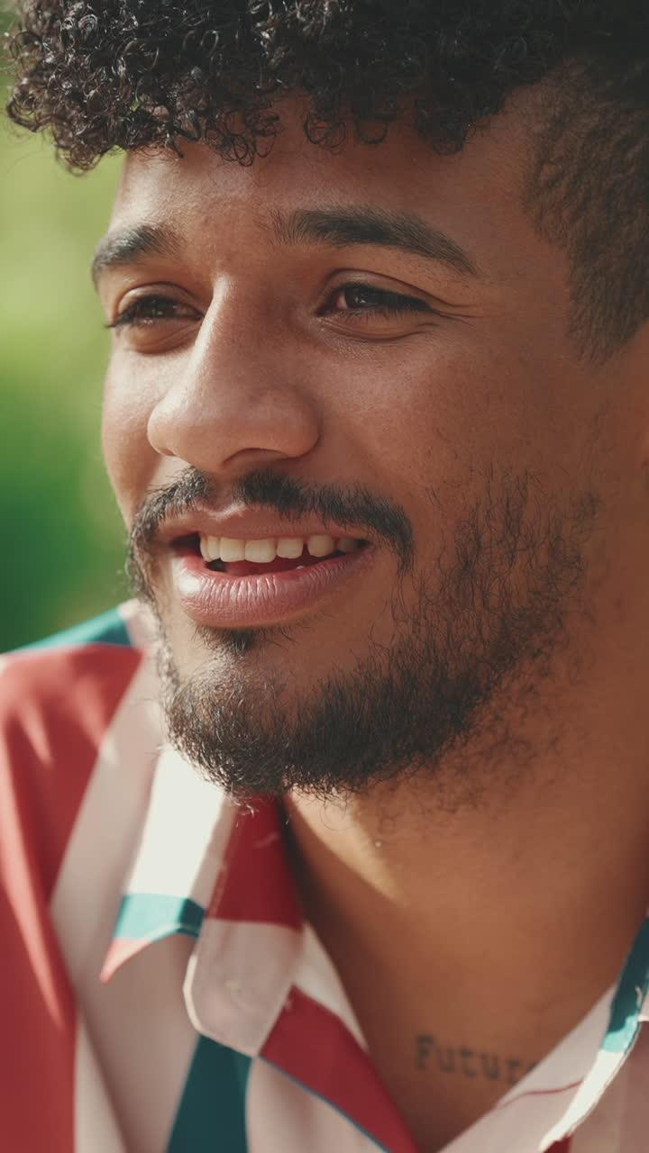 Portrét usměvavého muže s kudrnatými vlasy